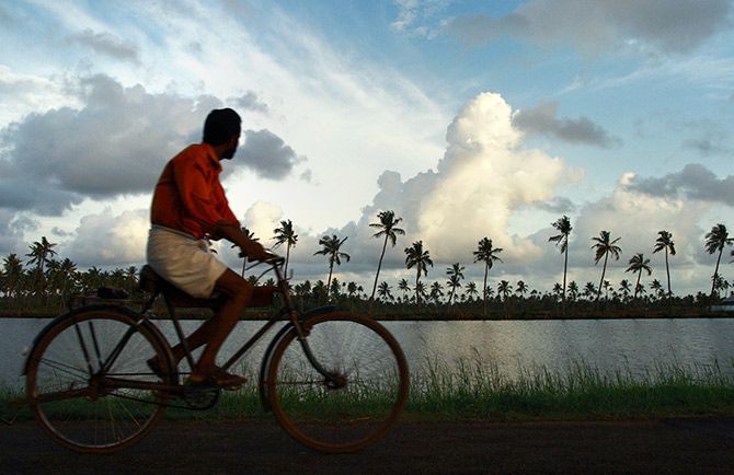 The monsonn, a bicycle and Kochi, Kerala. Photograph: Sivaram V/Reuters.