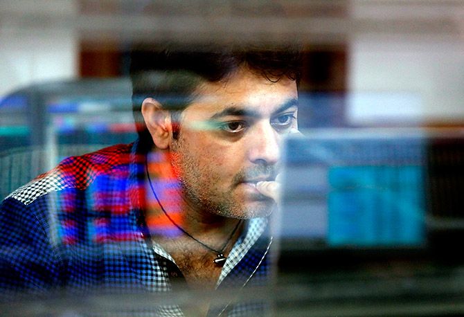 A broker reacts while trading at his computer terminal at a stock brokerage firm in Mumbai, India, February 26, 2016. Indian bonds, shares and the rupee gained on Friday after a key government report on the economy was seen as calling for fiscal prudence and stable inflation, while also acknowledging risks to the growth outlook. Photograph: Shailesh Andrade/Reuters.