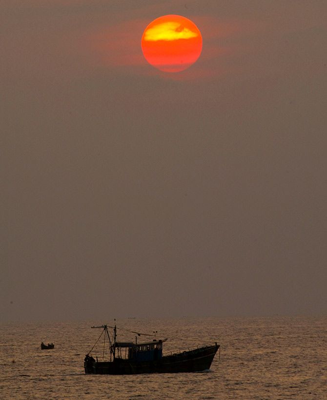 A fishing boat sits on the sea near Kovalam Beach, about 20 km (12 miles) south of Trivandrum, in Kerala. Photograph: Pawel Kopczynski/Reuters.