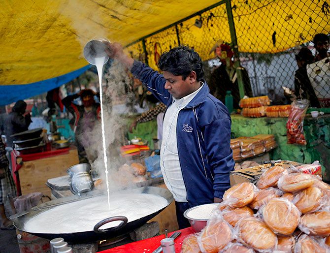 A milk monent at roadside chai shop in New Delhi. Photograph: Anindito Mukherjee/Reuters.