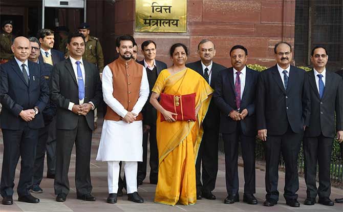 Finance Minister Nirmala Sitharaman, flanked by the minister of state for finance, chief economic adviser and other finance ministry officials, leaves the finance ministry for Parliament, February 1, 2020. Photograph: Press Information Bureau