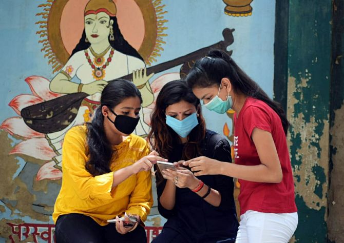 Girls check their UP board exam result on a mobile screen, in Agra on Saturday. (ANI Photo)