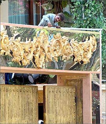 A worker adds the final touches to the gate