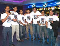 Fans wearing t-shirts featuring the star, pose for photographs