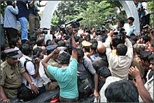 Crowds gather outside the police station