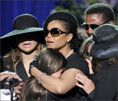 Paris is embraced by her aunts, Janet Jackson (centre) and La Toya Jackson (left)