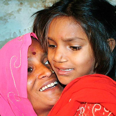 Shimla Devi holds her daughter Pinki