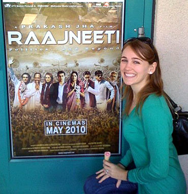 Sarah Thompson with a poster of Raajneeti in the US