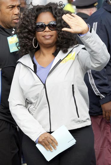 Oprah Winfrey waves to photographers as she arrives for her charity walk in New York