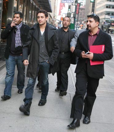 Imran Khan and his entourage make their way down 380 Madison Avenue in New York