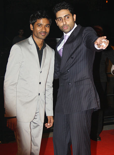 Guests Dhanush and Abhishek Bachchan walk the red carpet