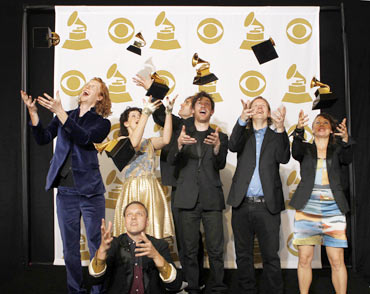 Rock group Arcade Fire throws their Album of the Year awards in the air for The Suburbs