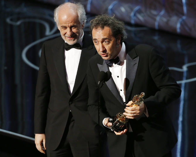 Paulo Sorrentino delivres his acceptance speech as actor Tony Servillo looks on