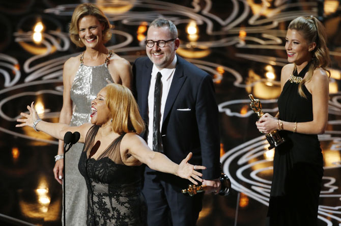 Darlene Love sings as Morgan Neville and Caitrin Rogers (R) look on