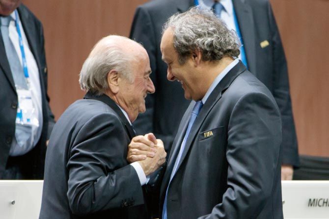  FIFA president Sepp Blatter (left) shakes hands with UEFA president Michel Platini