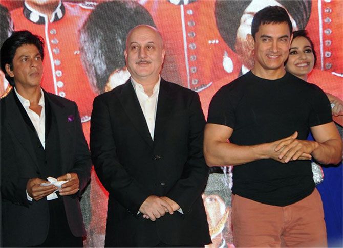 Shah Rukh Khan, left, and Aamir Khan, right, flank Anupam Kher who defended SRK, but asked Aamir if India did not make him who he is.