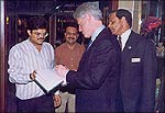 President Clinton signs the Ganeshi Lal store guestbook