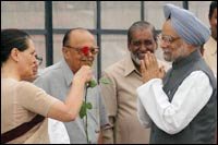 Congress chief Sonia Gandhi greets Manmohan Singh before he embarked on his first overseas trip