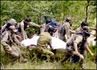 Paramilitary forces taking the body to hospital