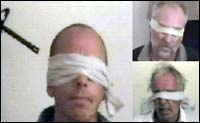 A composite picture of grabs taken from a video aired on September 18 by Al-Jazeera news channel showing three blindfolded men, two Americans and a Briton, held hostage by a group in Iraq