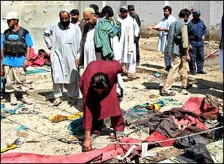 Afghan police officers and local residents at the Mullah Abdul Fayaz Mosque in Kandahar after a suicide attack claimed 20 lives. AP Photo