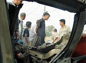 People check the aftermath of a car bomb explosion in Klais, some 45 km north of Baqouba, June 2. (AP PHOTO) 