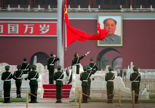 A Chinese paramilitary police honor guard raises the national flag in Beijing's Tiananmen Square at dawn on Saturday June 4, the 16th anniversary of the bloody military   crackdown on pro-democracy protestors which left hundreds dead in the streets of the Chinese capital. (AP photo/Greg Baker)