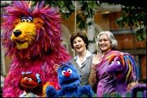 US First lady Laura Bush, (C), stand with Nafisa Ali, chairperson of the Children's Film Society of India as they meet the cast of the Indian version of the children's TV show Sesame Street, called "Galli Galli Sim Sim", at their film studio on the outskirts of New Delhi.