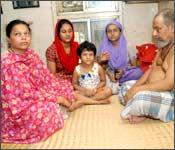 Samina (centre, in red) and Zarina with their parents and young sibling