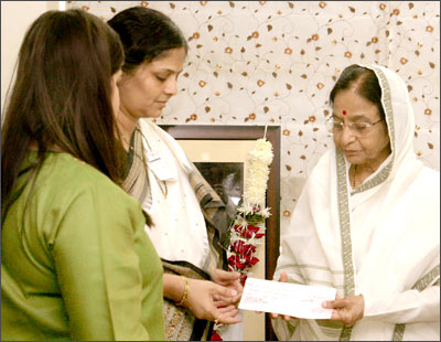 President Pratibhatai Patil presenting a cheque to Mrs Smita Salaskar and Divya Salaskar at her residence