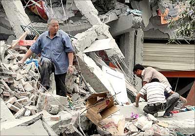 Rescuers search in the rubble of the collapsed Juyuan middle school in China's Sichuan province on Monday.