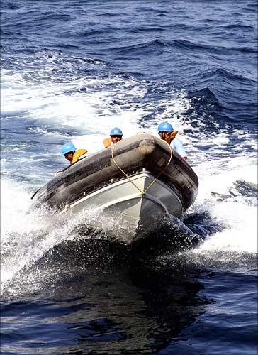 Naval commandos plough through the sea during a mock drill off the Porbandar coast