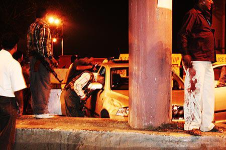 Police examine the Skoda after Kasab was captured