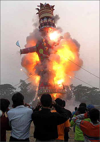 Devotees watch as an effigy of Ravana, stuffed with fire-crackers, is set ablaze.