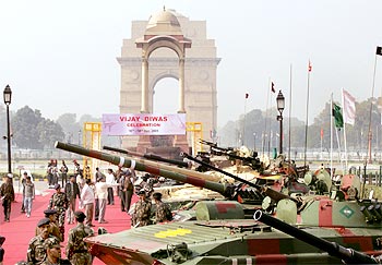 Soldiers stand beside their displayed tanks at the India Gate in New Delhi