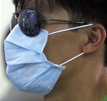 A man wears a protective mask while waiting for a health check at a hospital in Hanoi
