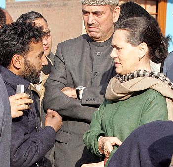 Congress president Sonia Gandhi listens to a Kashmiri as Azad watches