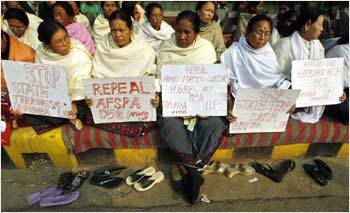 Women hold placards during a protest against the Armed Forces Special Powers Act  in New Delhi
