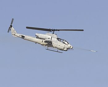 A United States Marine Corps Cobra helicopter fires a missile