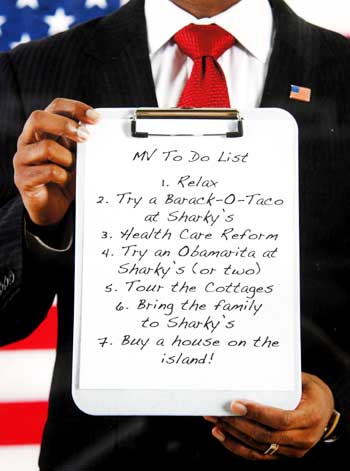 A restaurant menu, held by a model in a suit representing Obama, advises what vacationers can do, including sampling a Barack-O-Taco, during the president's visit to Martha's Vineyard.