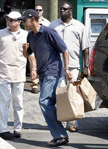Obama carries two bags containing takeout food that he bought from Nancy's restaurant in Oak Bluffs, Martha's Vineyard