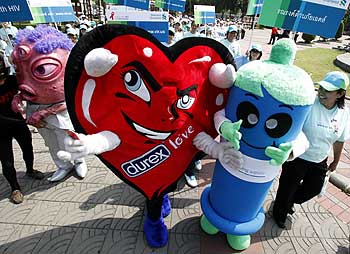 Mascots in the shape of a heart and a condom participate in a march