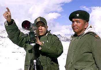 An Indian soldier points towards the border with China in Tawang, Arunachal Pradesh.