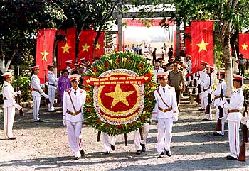 An honour guard carries a wreath in memory of Vietnamese soldiers, killed in the war with US