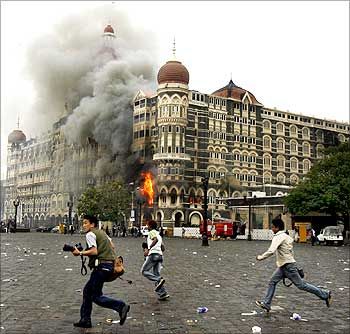 The media flees gunshots fired by terrorists inside the Taj.