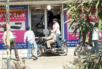 TRS activists throw stones at the Netraj theatre in Secunderabad during a protest