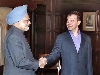 Russia's President Dmitry Medvedev (R) shakes hands with India's Prime Minister Manmohan Singh as they meet at the presidential residence in Barvikha, outside Moscow