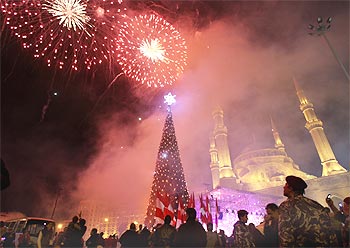 Fireworks explode as a giant Christmas tree is illuminated at a Christmas parade in downtown Beirut