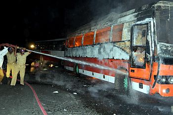 Firemen trying to salvage a burning bus