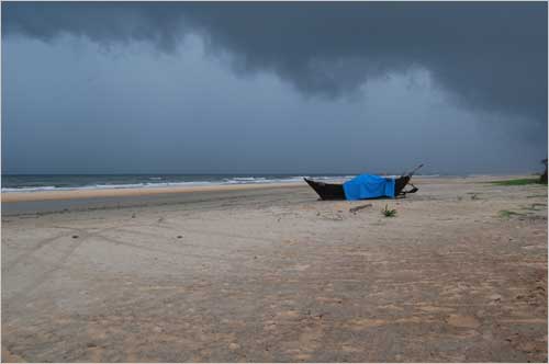 The lonely boat on the rain washed beach.